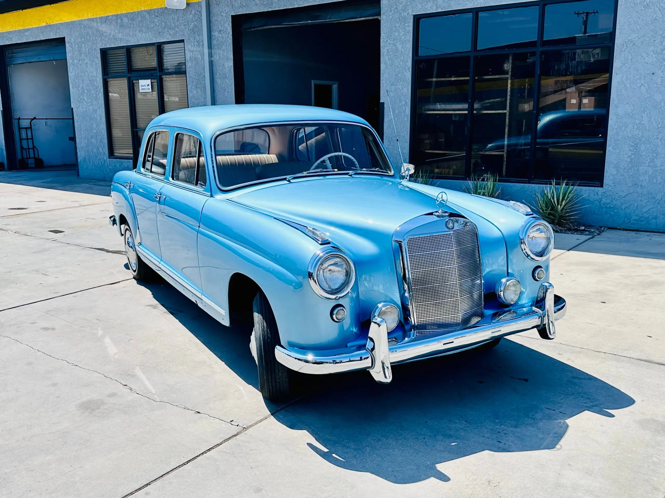 Classic 1957 Mercedes 220S with custom metallic blue paint, restored by Executive Auto Body & Paint in Lancaster, CA